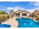 Serene backyard with a sparkling pool, lush greenery, and comfortable seating, perfect for relaxation and entertainment at 22415 N 34Th Ln, Phoenix, AZ 85027