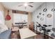 Cozy bedroom featuring a ceiling fan, hardwood floors, and a variety of musical instruments at 22415 N 34Th Ln, Phoenix, AZ 85027