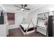 This bedroom is fully furnished with a custom platform bed, desk, bookshelf, and ceiling fan at 22415 N 34Th Ln, Phoenix, AZ 85027