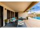 Inviting covered patio with stylish outdoor furniture and decor, overlooking the pool and backyard at 22415 N 34Th Ln, Phoenix, AZ 85027