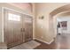 Inviting foyer with beautiful wood flooring, arched doorway, and decorative details at 22415 N 34Th Ln, Phoenix, AZ 85027