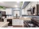 View of kitchen with island and counter with white cabinetry and blue accents at 22415 N 34Th Ln, Phoenix, AZ 85027