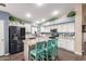 Bright kitchen featuring white cabinets, granite countertops, and an island with seating at 22415 N 34Th Ln, Phoenix, AZ 85027