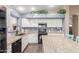 View of the kitchen with white cabinets, granite countertops, and black appliances at 22415 N 34Th Ln, Phoenix, AZ 85027
