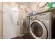 This laundry room features modern washer and dryer units with a top storage shelf at 22415 N 34Th Ln, Phoenix, AZ 85027