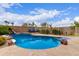 Backyard oasis boasting a stunning pool with custom rock features and a tranquil outdoor lounge area at 22415 N 34Th Ln, Phoenix, AZ 85027