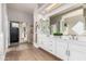 Bright bathroom boasts a double sink vanity, walk-in shower and closet, and modern finishes at 22477 S 197Th Cir, Queen Creek, AZ 85142