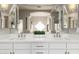 Elegant bathroom featuring double sinks, quartz countertops, and decorative accents at 22477 S 197Th Cir, Queen Creek, AZ 85142