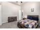 Cozy bedroom featuring carpet floors and a plaid-patterned bed at 22477 S 197Th Cir, Queen Creek, AZ 85142
