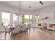 Bright dining room with a modern light fixture, large windows, and elegant decor at 22477 S 197Th Cir, Queen Creek, AZ 85142