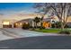 Exterior view of home featuring a three-car garage and spacious driveway at 22477 S 197Th Cir, Queen Creek, AZ 85142