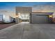 A multi-car garage with additional storage space and an extended driveway at 22477 S 197Th Cir, Queen Creek, AZ 85142