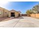 A detached garage with an open garage door next to a concrete driveway and desert landscaping at 22477 S 197Th Cir, Queen Creek, AZ 85142