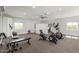 Spacious home gym equipped with exercise machines, weights, and ample natural light at 22477 S 197Th Cir, Queen Creek, AZ 85142