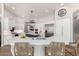 Gourmet kitchen features a center island with seating, white cabinetry, and stainless steel appliances at 22477 S 197Th Cir, Queen Creek, AZ 85142