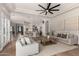 Bright living room featuring modern furnishings, hardwood floors, and an open layout with a kitchen view at 22477 S 197Th Cir, Queen Creek, AZ 85142