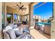 Stylish outdoor patio featuring comfortable seating, ceiling fans, and views of the pool and backyard at 22477 S 197Th Cir, Queen Creek, AZ 85142