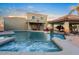 Sparkling backyard pool and spa with water features, stone accents, and outdoor seating for relaxation and entertaining at 22477 S 197Th Cir, Queen Creek, AZ 85142