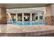 Covered outdoor pool with decorative water feature and elegant patio area at 22477 S 197Th Cir, Queen Creek, AZ 85142