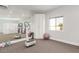 Bright workout area with fitness equipment, storage, and a neutral color palette for a calming atmosphere at 22477 S 197Th Cir, Queen Creek, AZ 85142