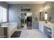 Elegant bathroom with double vanity, soaking tub, and walk-in closet at 22488 N Mulligan Dr, Maricopa, AZ 85138