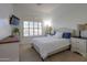 Bright bedroom with a queen-size bed and ample natural light at 22488 N Mulligan Dr, Maricopa, AZ 85138