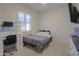 Cozy bedroom featuring a full-size bed and built-in desk at 22488 N Mulligan Dr, Maricopa, AZ 85138