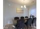 Formal dining room featuring a dark wood table and six black velvet chairs at 22488 N Mulligan Dr, Maricopa, AZ 85138