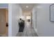 Long hallway with gray floors, leading to other rooms at 22488 N Mulligan Dr, Maricopa, AZ 85138