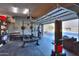 Well-equipped home gym in the garage at 22488 N Mulligan Dr, Maricopa, AZ 85138