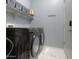 Convenient laundry room with washer, dryer, and shelving at 22488 N Mulligan Dr, Maricopa, AZ 85138