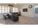 Relaxing living room featuring a large sectional sofa and a piano at 22488 N Mulligan Dr, Maricopa, AZ 85138