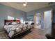 Main bedroom with king bed, en-suite bathroom access, and large windows at 22488 N Mulligan Dr, Maricopa, AZ 85138