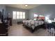 Bright main bedroom with a king-size bed and ceiling fan at 22488 N Mulligan Dr, Maricopa, AZ 85138