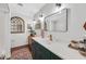 Clean bathroom with dark green vanity and tile floors at 2323 E Concorda Dr, Tempe, AZ 85282