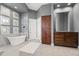 Elegant bathroom featuring a soaking tub and rich wood cabinets at 23238 N 94Th Pl, Scottsdale, AZ 85255