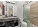 Modern bathroom with a large shower and dark vanity at 23238 N 94Th Pl, Scottsdale, AZ 85255