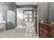 Luxurious bathroom featuring a freestanding tub and glass block wall at 23238 N 94Th Pl, Scottsdale, AZ 85255