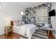 Charming bedroom with a unique photo wall and hardwood floors at 23238 N 94Th Pl, Scottsdale, AZ 85255