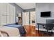Bedroom with wood floors, built-in shelving, and access to a full bathroom at 23238 N 94Th Pl, Scottsdale, AZ 85255