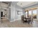 Elegant dining room featuring a rich wood table and access to a patio at 23238 N 94Th Pl, Scottsdale, AZ 85255