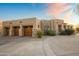 Three-car garage and desert landscaping highlight this home at 23238 N 94Th Pl, Scottsdale, AZ 85255