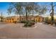 Stunning desert home with circular driveway, mature trees, and landscape lighting at 23238 N 94Th Pl, Scottsdale, AZ 85255