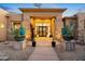 Elegant entryway with large glass doors, stone accents, and unique planters at 23238 N 94Th Pl, Scottsdale, AZ 85255