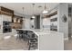 Modern kitchen with white cabinets, stainless steel appliances, and breakfast bar at 23238 N 94Th Pl, Scottsdale, AZ 85255