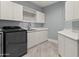 Spacious laundry room with white cabinets and modern appliances at 23238 N 94Th Pl, Scottsdale, AZ 85255