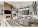 Spacious living room with a modern fireplace and large windows at 23238 N 94Th Pl, Scottsdale, AZ 85255