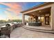 Outdoor kitchen and patio with seating area, steps down to the pool at 23238 N 94Th Pl, Scottsdale, AZ 85255