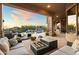 Comfortable patio seating area with a fire pit and views of the pool and desert landscape at 23238 N 94Th Pl, Scottsdale, AZ 85255