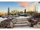 Steps leading down to a beautiful pool and spa, surrounded by desert landscaping at 23238 N 94Th Pl, Scottsdale, AZ 85255